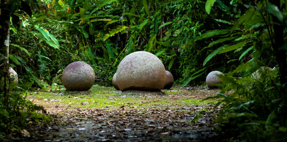 A group of rocks sitting in the middle of a forest.