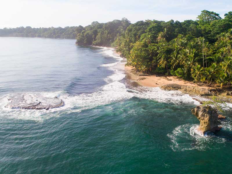 An aerial view of a tropical beach and ocean.