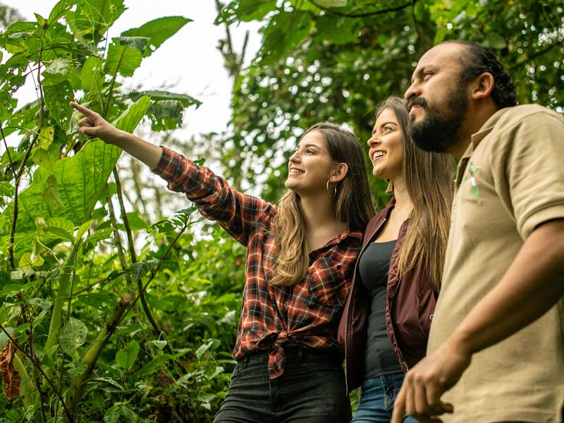 A group of people standing next to each other in a forest.