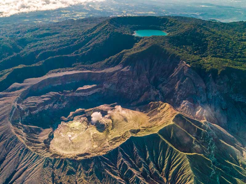 An aerial view of a mountain range with a lake in the middle.