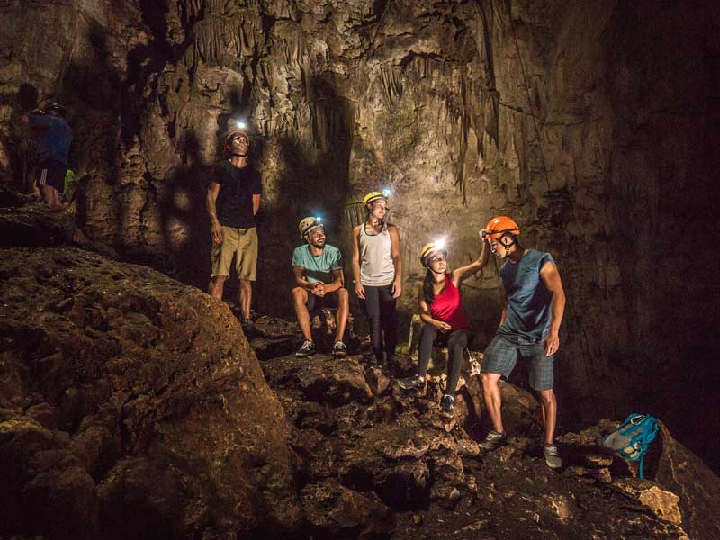 A group of people standing in a cave.