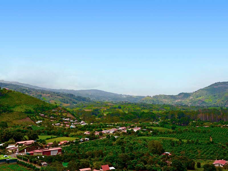 A scenic view of a small town in the mountains.