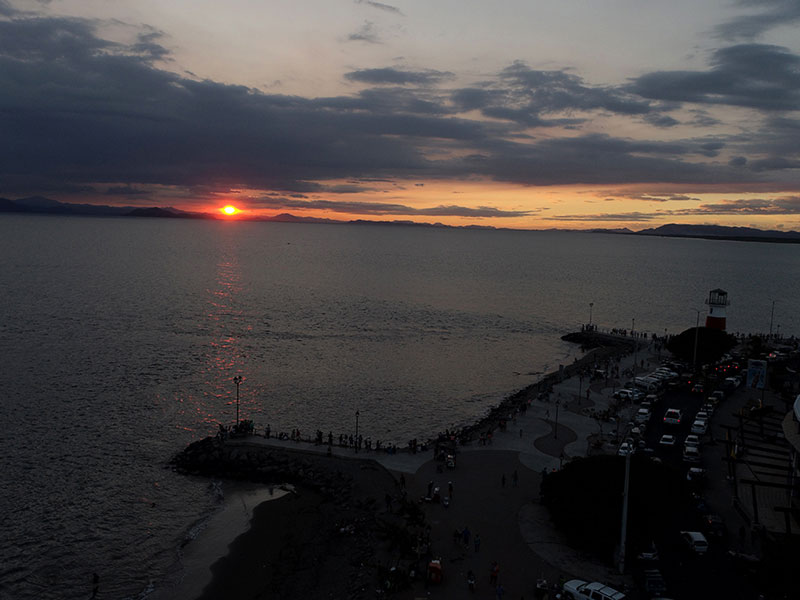 A large body of water with a sunset in the background.