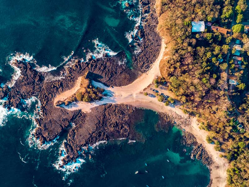 An aerial view of a beach and ocean.