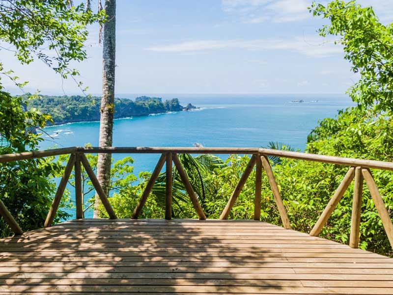 A wooden deck with a view of the ocean.