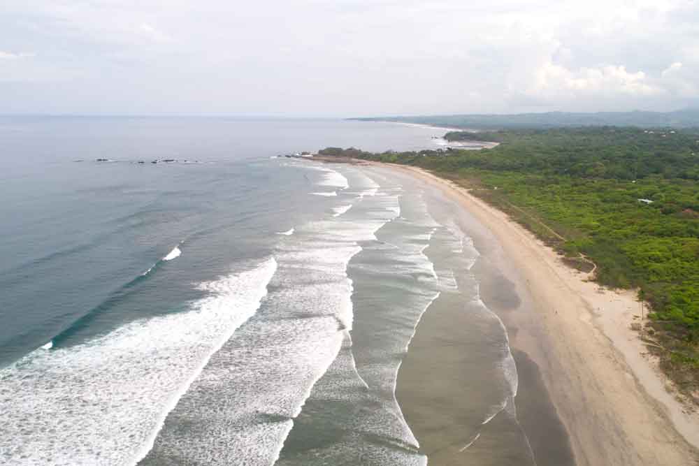 An aerial view of a beach and ocean.