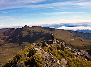 A person standing on top of a mountain.