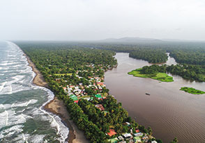 An aerial view of a tropical island with a beach.