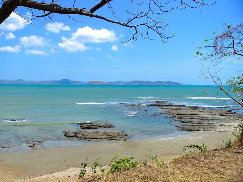 A view of the ocean from the shore of a beach.