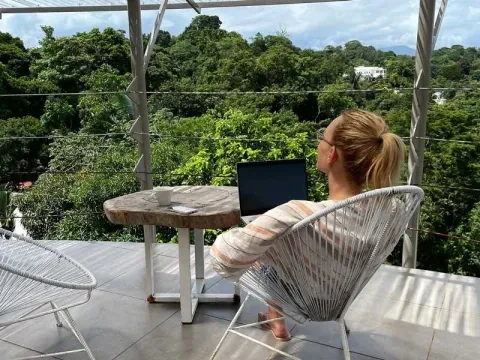 woman sitting on porch with laptop