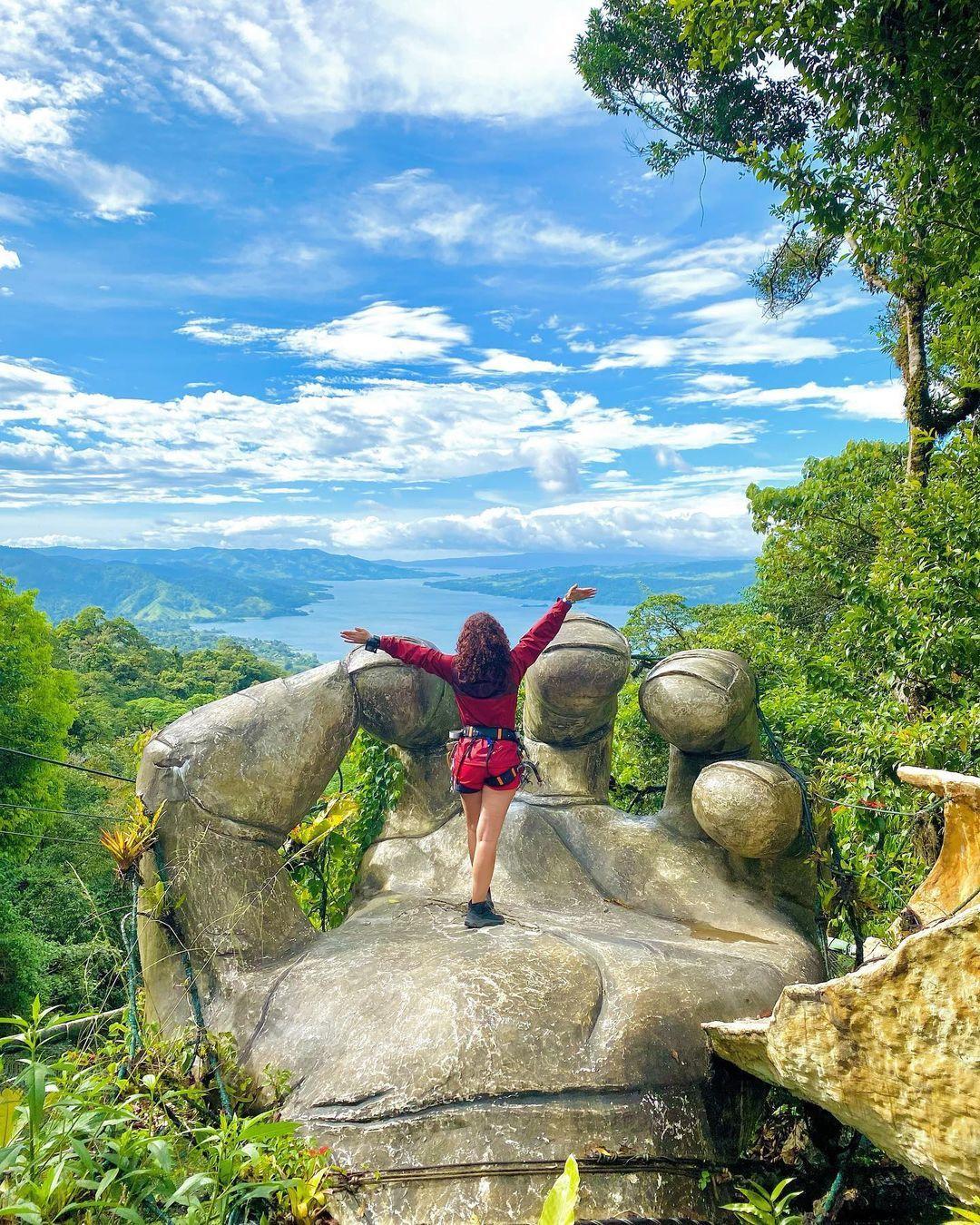 A person standing on top of a statue