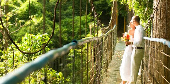 bride and groom on suspension bridge