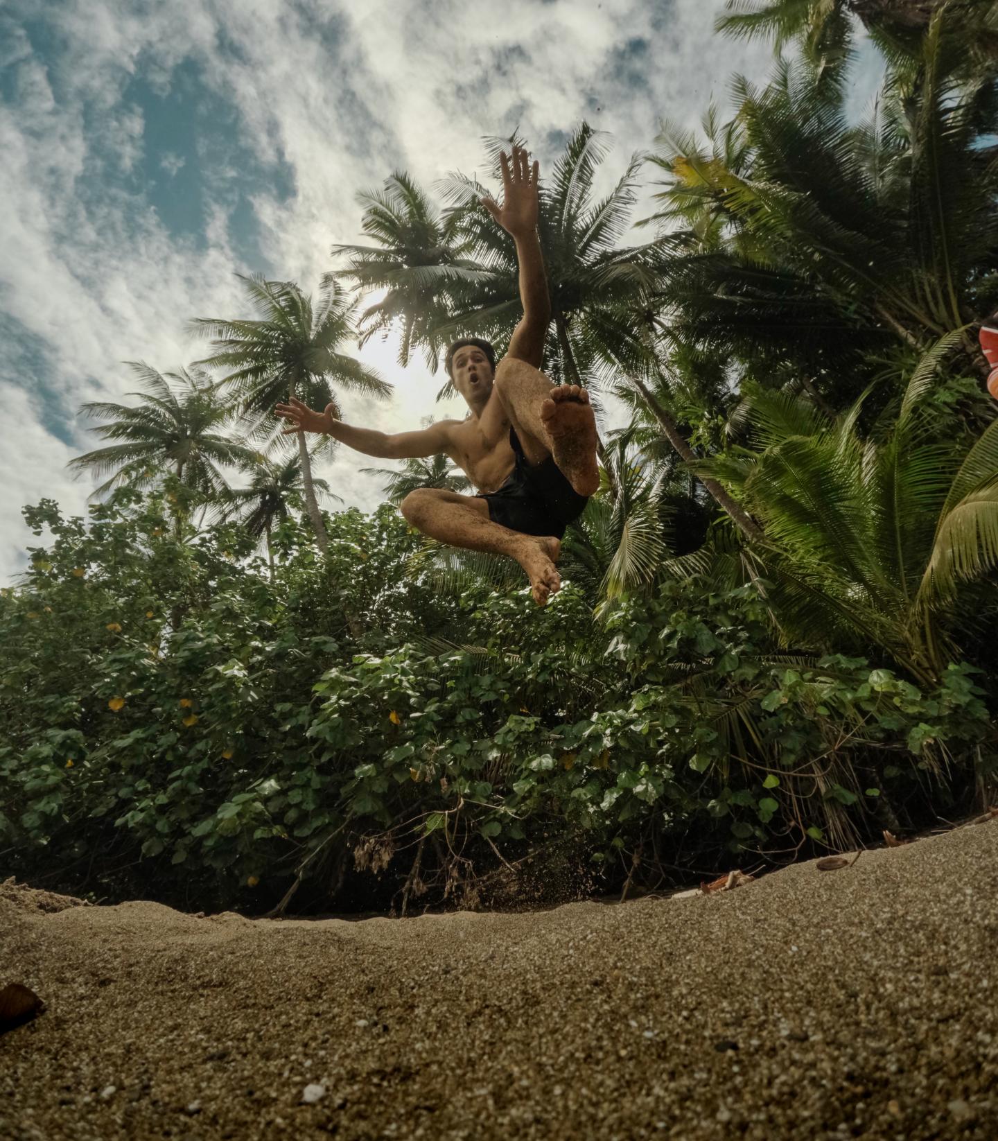 man jumping on beach