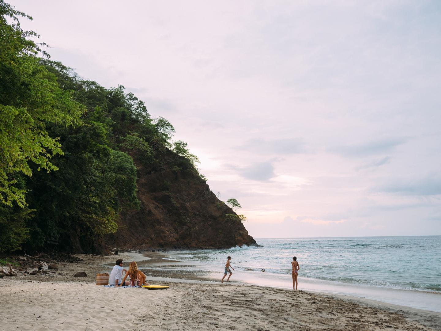 family playing on a beach