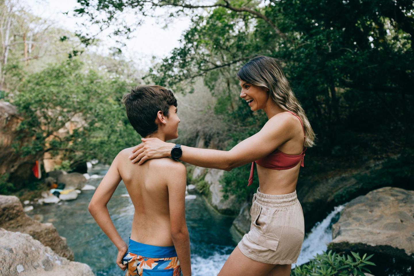 Mother and son at the top of a waterfall at Las Chorreras, Hacienda Guachipelin